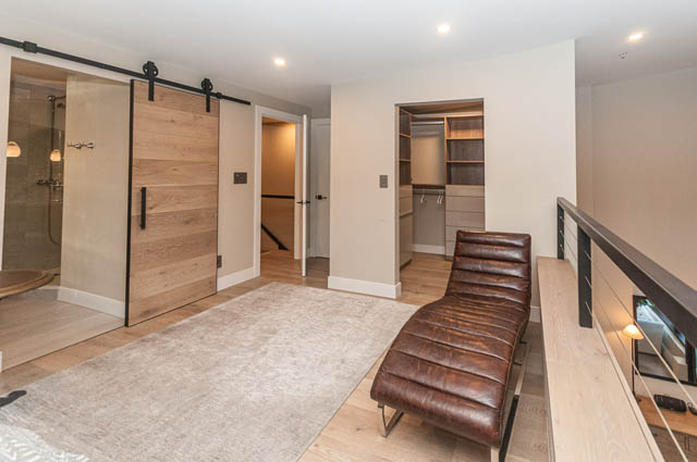 Bright living room with hardwood floors and sliding barn door entry. - PH7 - 1688 Robson Street, Vancouver Downtown