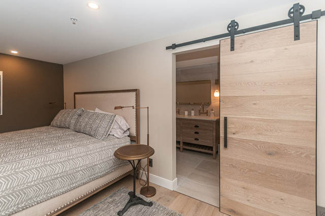Bright bedroom with sliding barn door and wooden flooring. - PH7 - 1688 Robson Street, Vancouver Downtown