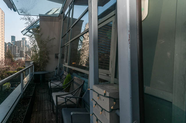 Furnished balcony with city view and modern glass railings. - PH7 - 1688 Robson Street, Vancouver Downtown