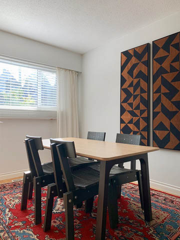 Dining area with patterned wall panels and red rug, modern furniture. - 850 E 23rd Avenue, Vancouver East Side