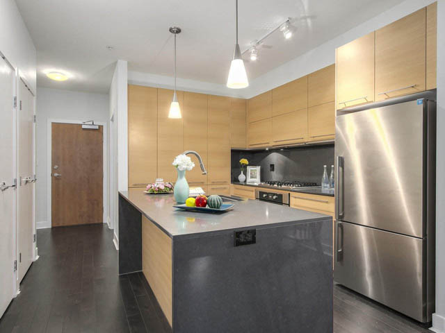 Bright kitchen with modern stainless steel appliances, granite countertops, and hardwood floors. - 105 - 2020 W 12th Ave, Vancouver West Side