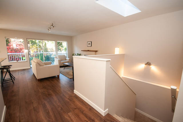 Bright living room with hardwood floors and city view. - 1528 Edgewater Lane, North Vancouver