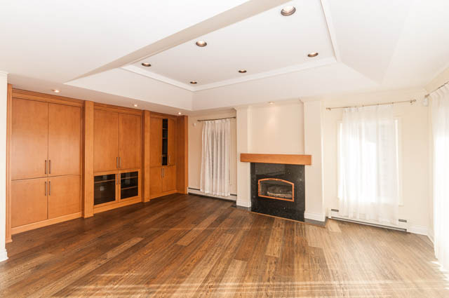 Bright kitchen with wooden cabinets, granite countertops, and hardwood floors. - 3399 Thompson Cres., West Vancouver