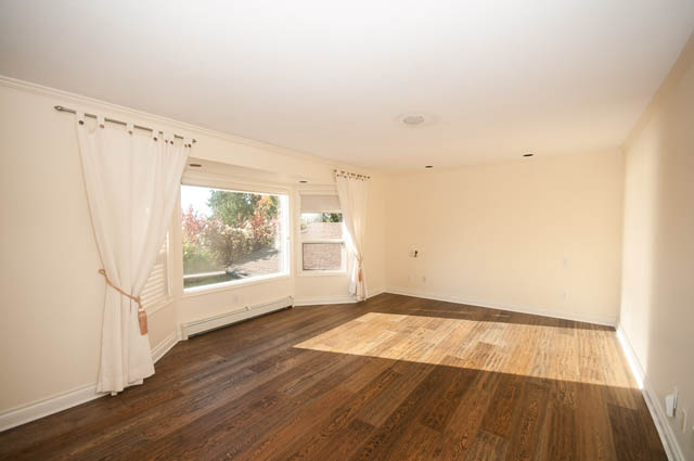 Spacious living room with hardwood floors and large windows. - 3399 Thompson Cres., West Vancouver