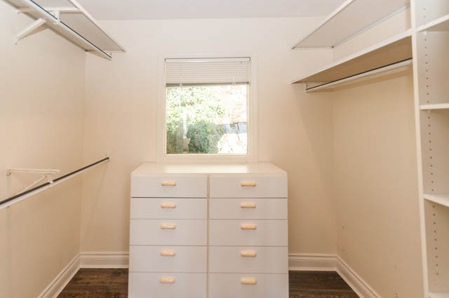 Spacious walk-in closet with built-in shelves and drawers, natural light from window. - 3399 Thompson Cres., West Vancouver