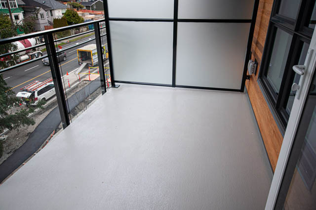 Spacious balcony with city view and modern glass doors. - 404 - 733 E 3rd St, North Vancouver