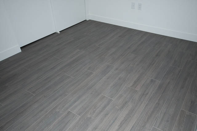 Bright living room with gray wood-look tile flooring. - 404 - 733 E 3rd St, North Vancouver