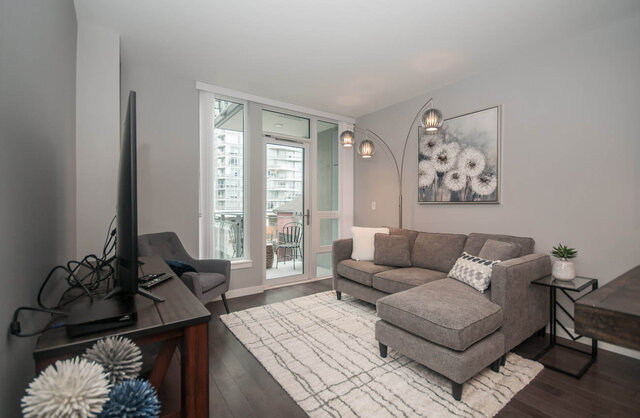 Spacious living room with modern furniture, large windows, and a city view. - 401 - 1708 Ontario Street, Vancouver West Side