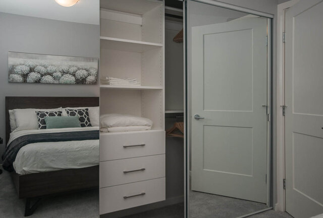 Furnished 1-bedroom + den with a cozy bed, built-in shelving, and a large closet with mirrored doors. - 401 - 1708 Ontario Street, Vancouver West Side