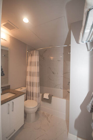 Spacious bathroom with marble countertops, modern shower, and sleek white cabinetry. - 401 - 1708 Ontario Street, Vancouver West Side