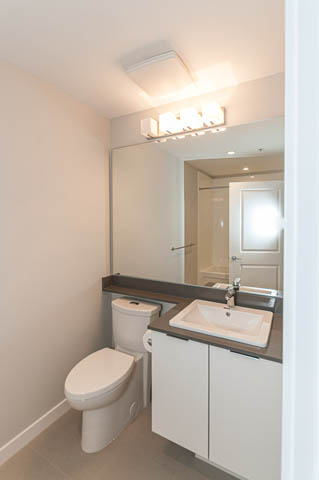 Bright bathroom with white countertop and modern sink. - 404 - 2632 Library Lane, North Vancouver
