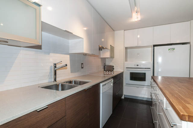 Bright kitchen with white cabinets, granite countertops, and stainless steel appliances. - 1001 - 175 West 2nd Street, North Vancouver