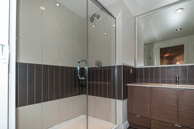 Furnished bathroom with modern shower and sleek countertop. - 1001 - 175 West 2nd Street, North Vancouver