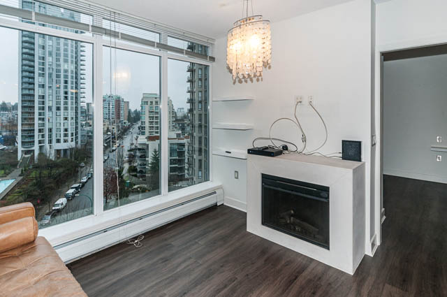 Bright living room with hardwood floors and city view, featuring a chandelier and modern decor. - 1001 - 175 West 2nd Street, North Vancouver