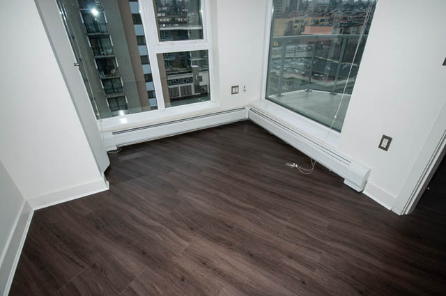Bright living room with hardwood floors and city view. - 1001 - 175 West 2nd Street, North Vancouver