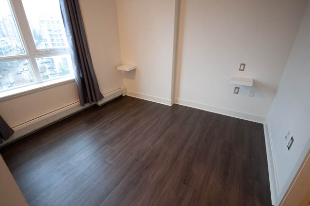 Bright living room with hardwood floors and city view. - 1001 - 175 West 2nd Street, North Vancouver