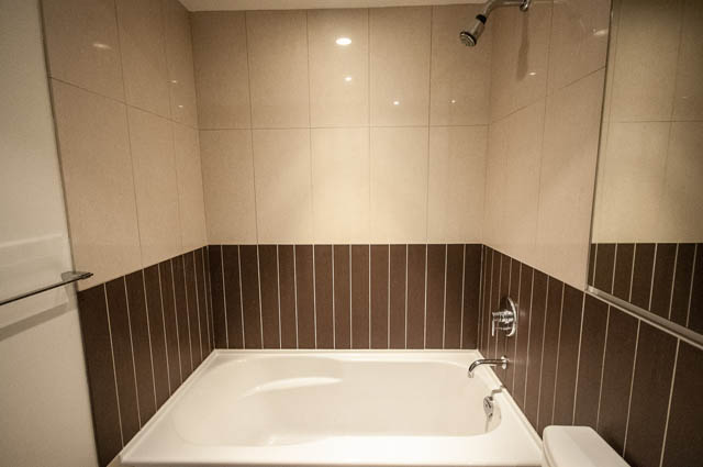 Furnished bathroom with modern tile and a bathtub. - 1001 - 175 West 2nd Street, North Vancouver