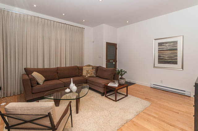 Furnished living room with hardwood floors and modern decor. - 1964 W 15th Ave, Vancouver West Side