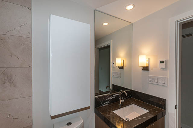 Furnished bathroom with marble countertops and modern lighting. - 1001 - 125 E 14th St, North Vancouver