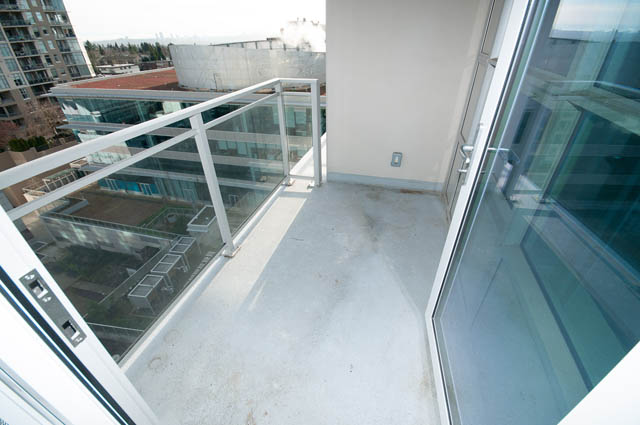 Bright balcony with glass railings and city view. - 1001 - 125 E 14th St, North Vancouver