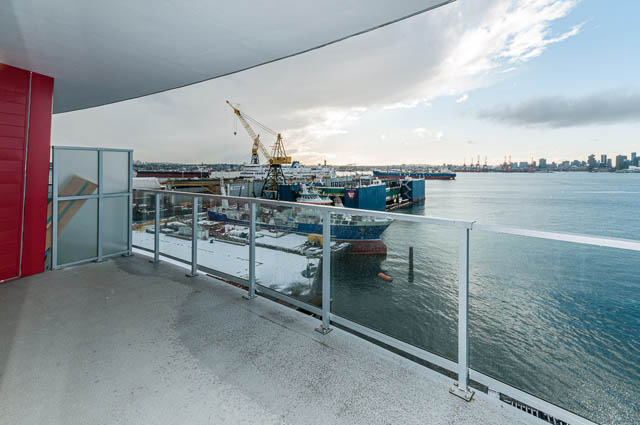 Bright living room with panoramic city view and modern balcony. - 702 - 185 Victory Ship Way, North Vancouver