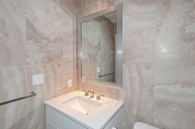 Spacious bathroom with marble countertops and a modern sink. - 702 - 185 Victory Ship Way, North Vancouver