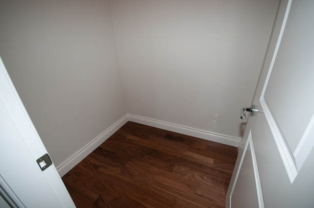 Bright hallway with hardwood floors and white walls. - 702 - 185 Victory Ship Way, North Vancouver