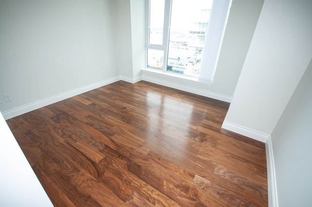 Bright living room with hardwood floors and a city view. - 702 - 185 Victory Ship Way, North Vancouver