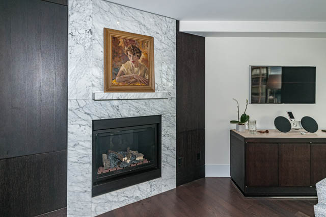 Furnished living room with marble fireplace, hardwood floors, and city view. - 601 - 1560 Homer Mews, Vancouver Downtown