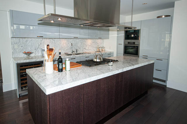 Bright kitchen with marble countertops, dark wood cabinets, and stainless steel appliances. - 601 - 1560 Homer Mews, Vancouver Downtown