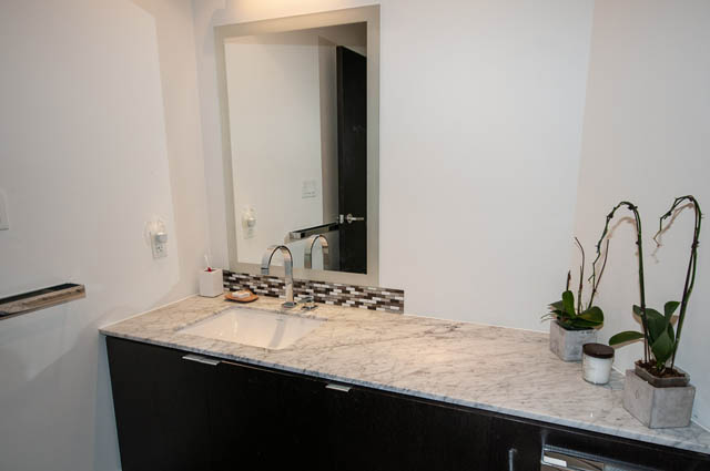 Modern bathroom with marble countertops and a sleek sink. - 601 - 1560 Homer Mews, Vancouver Downtown