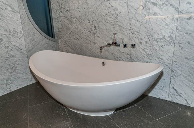 Spacious bathroom with marble walls and modern bathtub. - 601 - 1560 Homer Mews, Vancouver Downtown