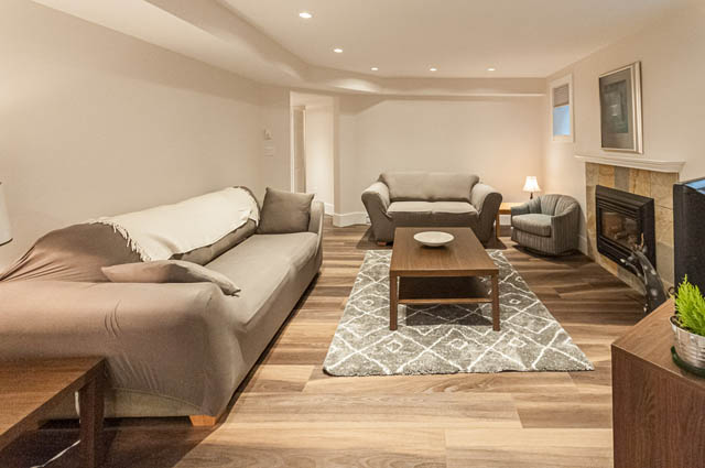 Furnished living room with hardwood floors and modern furniture. - SUITE - 2806 Munday Place, North Vancouver