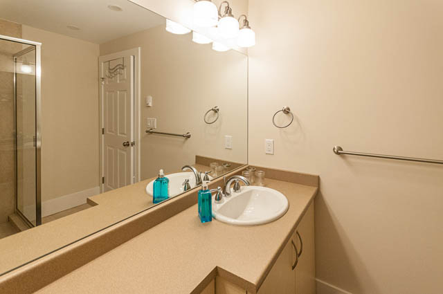 Bathroom with beige countertops and modern fixtures. - SUITE - 2806 Munday Place, North Vancouver