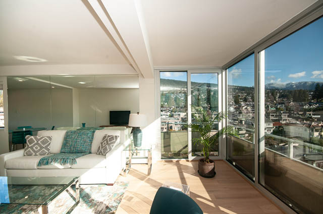 Bright living room with city view and modern furnishings. - 708 - 150 24th St, West Vancouver