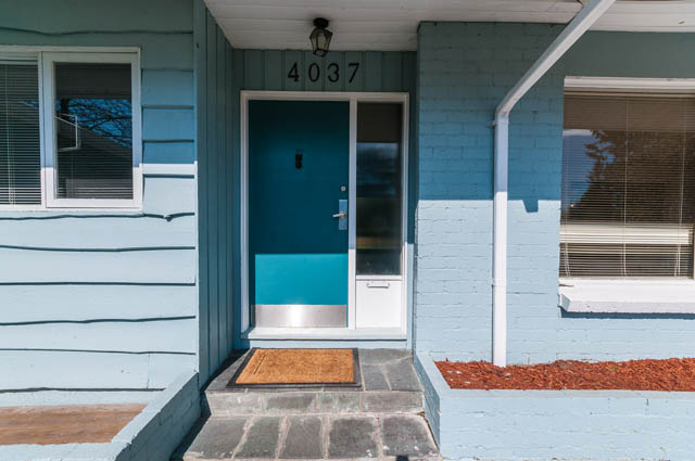 Furnished entryway with teal door and brick steps. - 4037 Ripple Road, West Vancouver