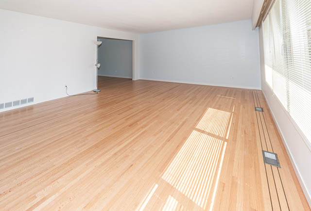 Bright living room with hardwood floors and large windows. - 4037 Ripple Road, West Vancouver