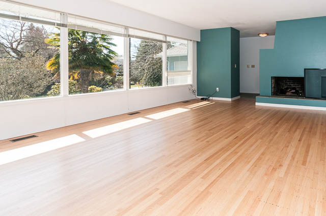 Bright living room with hardwood floors and large windows, showcasing a city view. - 4037 Ripple Road, West Vancouver