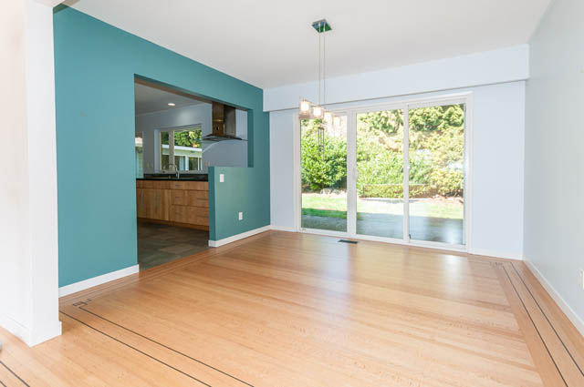 Bright kitchen with hardwood floors and a view of greenery outside. - 4037 Ripple Road, West Vancouver