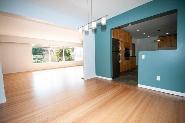 Bright living room with hardwood floors and a city view. - 4037 Ripple Road, West Vancouver