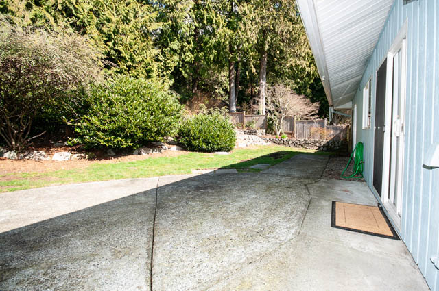 Furnished patio with concrete flooring and greenery in the background. - 4037 Ripple Road, West Vancouver