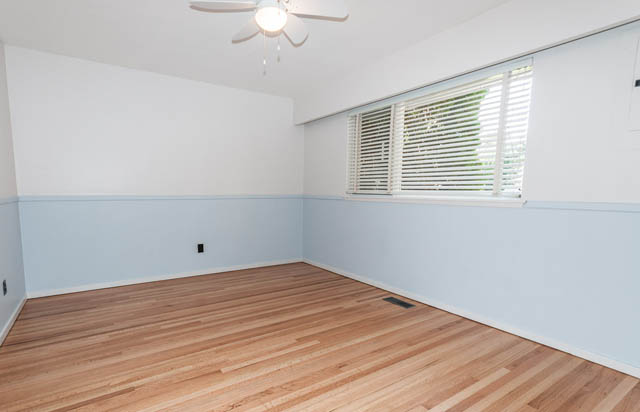 Bright living room with hardwood floors and large window. - 4037 Ripple Road, West Vancouver