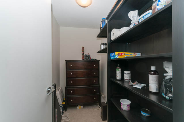 Compact den with dark wood shelving and drawers, neatly organized with essentials. - 1607 - 888 Homer St, Vancouver Downtown