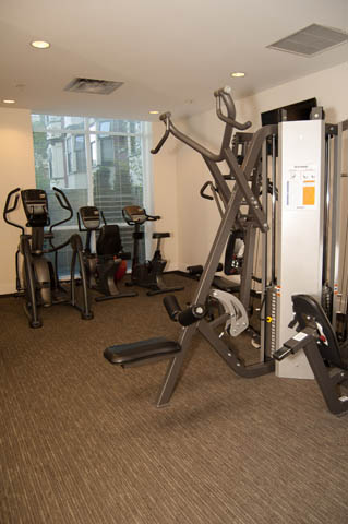 Spacious fitness room with cardio machines and weight equipment, perfect for workout enthusiasts. - 1607 - 888 Homer St, Vancouver Downtown