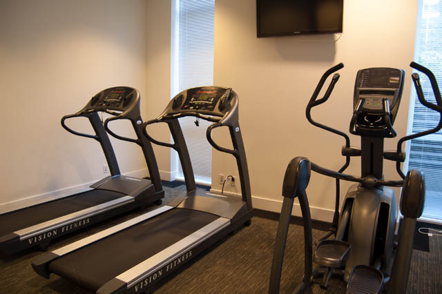 Bright and modern fitness room with treadmills and an elliptical, perfect for workout enthusiasts. - 1607 - 888 Homer St, Vancouver Downtown