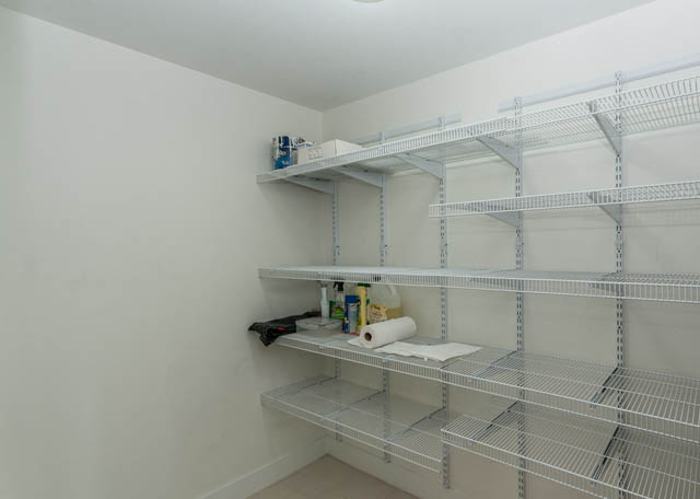 Spacious laundry room with white shelving and cleaning supplies. - 903 -1255 Seymour St, Vancouver Downtown
