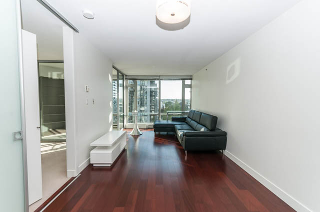 Spacious living room with hardwood floors, modern furniture, and a city view. - 903 -1255 Seymour St, Vancouver Downtown