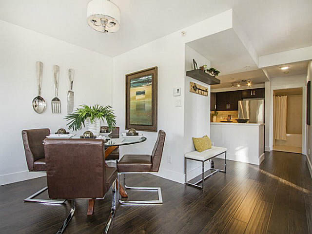 Modern dining area with hardwood floors, glass table, and sleek chairs. - 606 - 907 Beach Ave, Vancouver Downtown