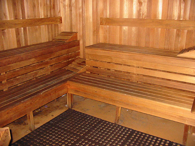 Spacious sauna with wooden benches and a textured mat floor, perfect for relaxation. - 606 - 907 Beach Ave, Vancouver Downtown