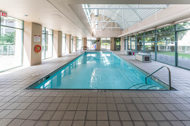 Spacious 1-bedroom + den condo with a large, well-lit indoor pool and tiled flooring. - 606 - 907 Beach Ave, Vancouver Downtown